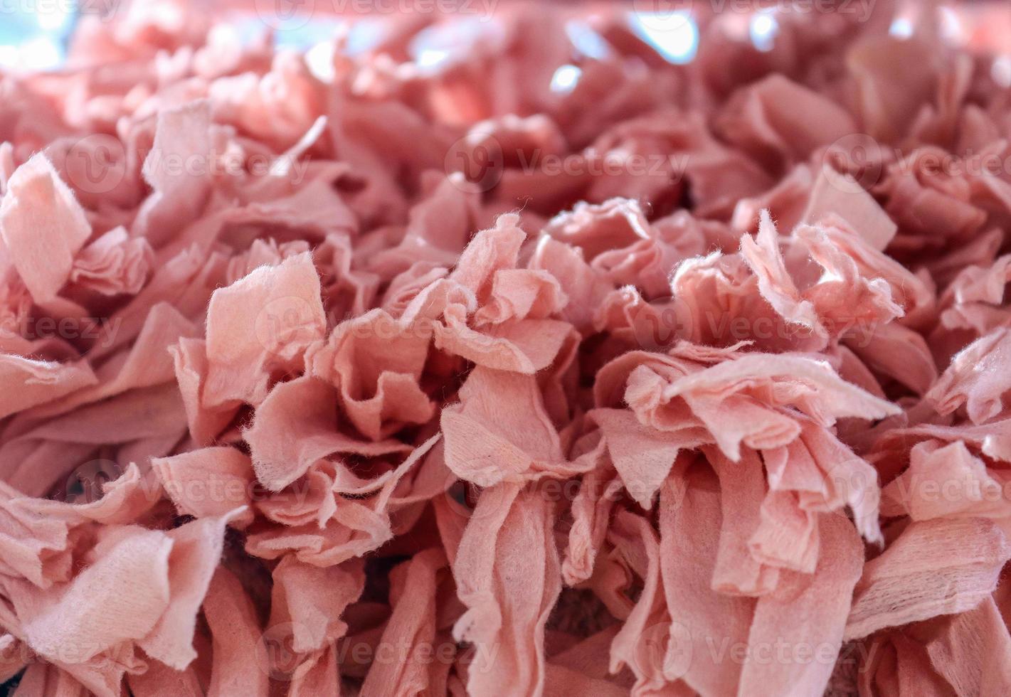 Detailed close up view on samples of cloth and fabrics in different colors found at a fabrics market photo
