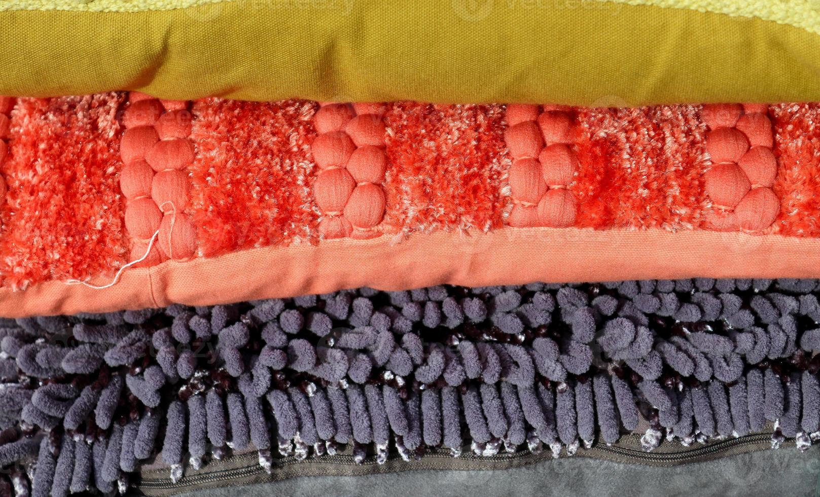 Detailed close up view on samples of cloth and fabrics in different colors found at a fabrics market photo