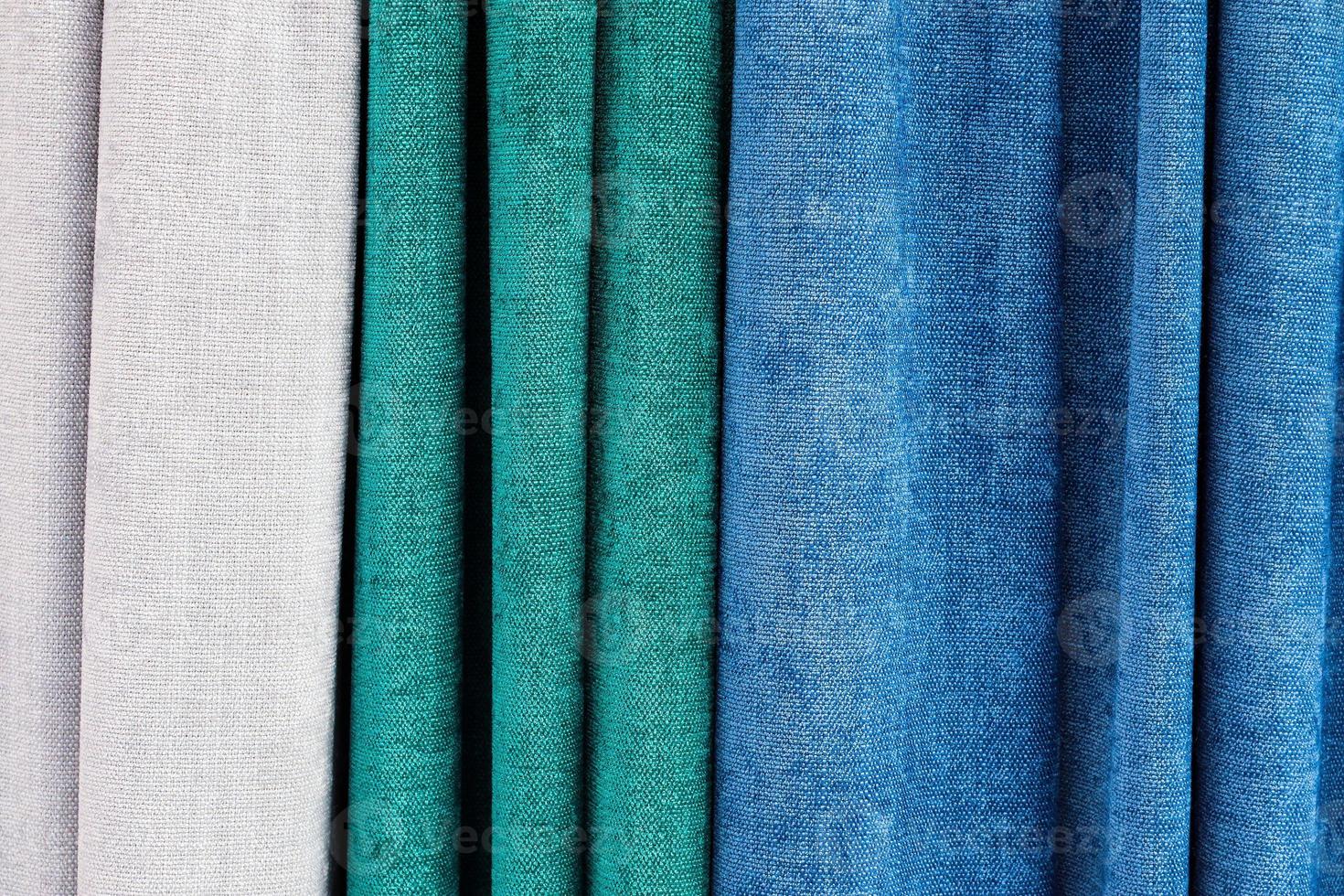 Detailed close up view on samples of cloth and fabrics in different colors found at a fabrics market photo