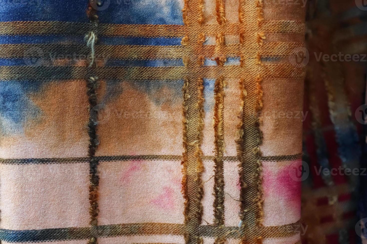 Detailed close up view on samples of cloth and fabrics in different colors found at a fabrics market photo