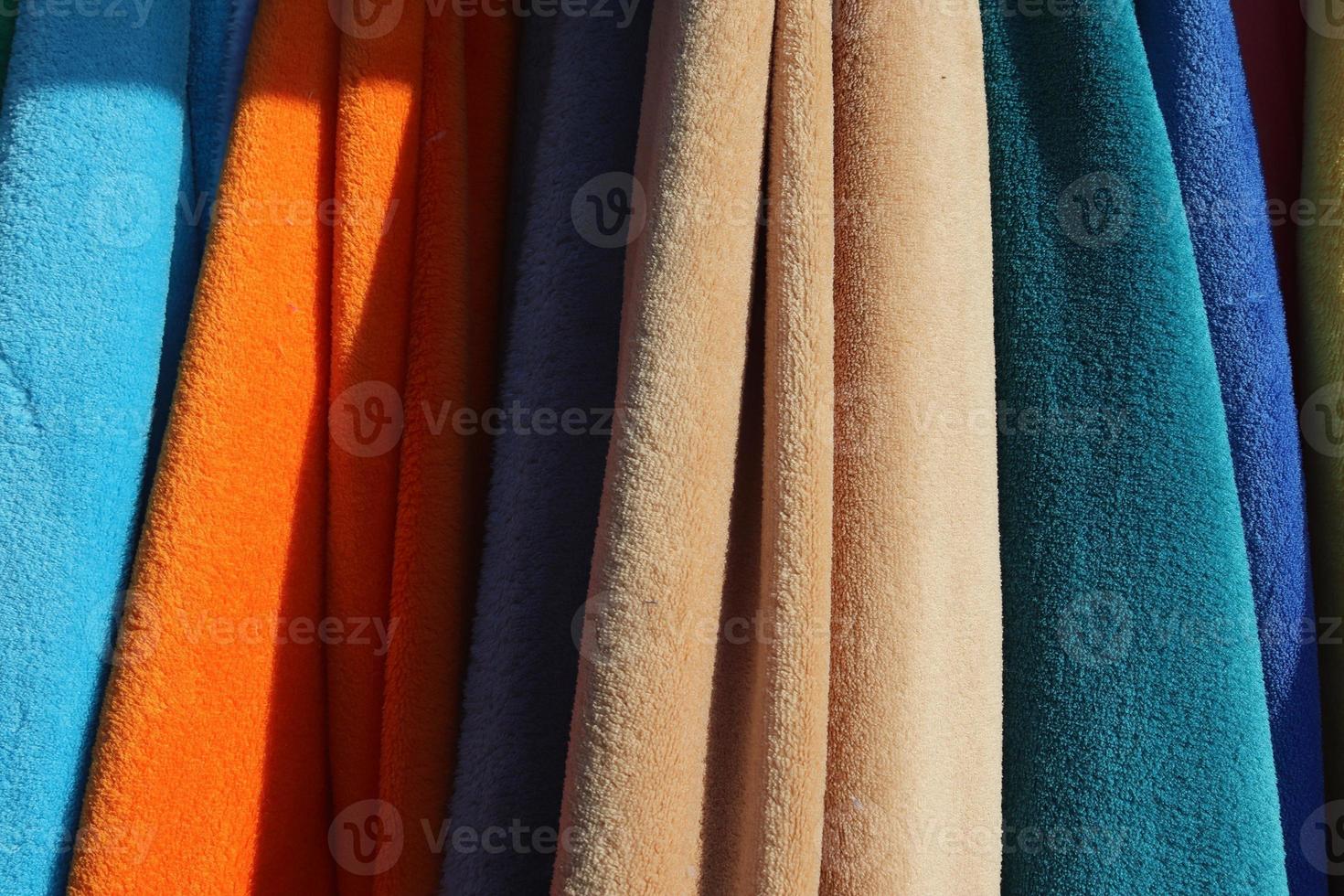 Detailed close up view on samples of cloth and fabrics in different colors found at a fabrics market photo