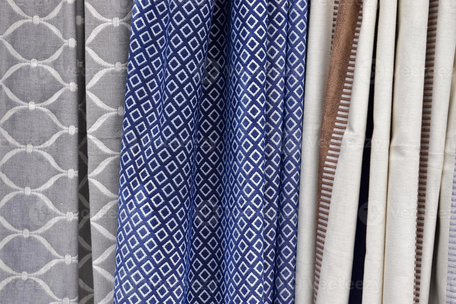 Detailed close up view on samples of cloth and fabrics in different colors found at a fabrics market photo