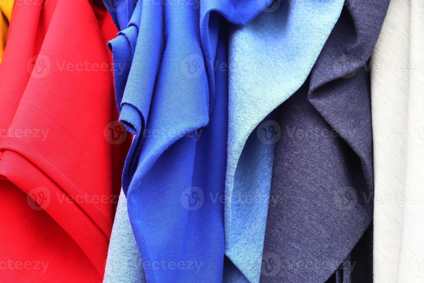 Detailed close up view on samples of cloth and fabrics in different colors found at a fabrics market photo