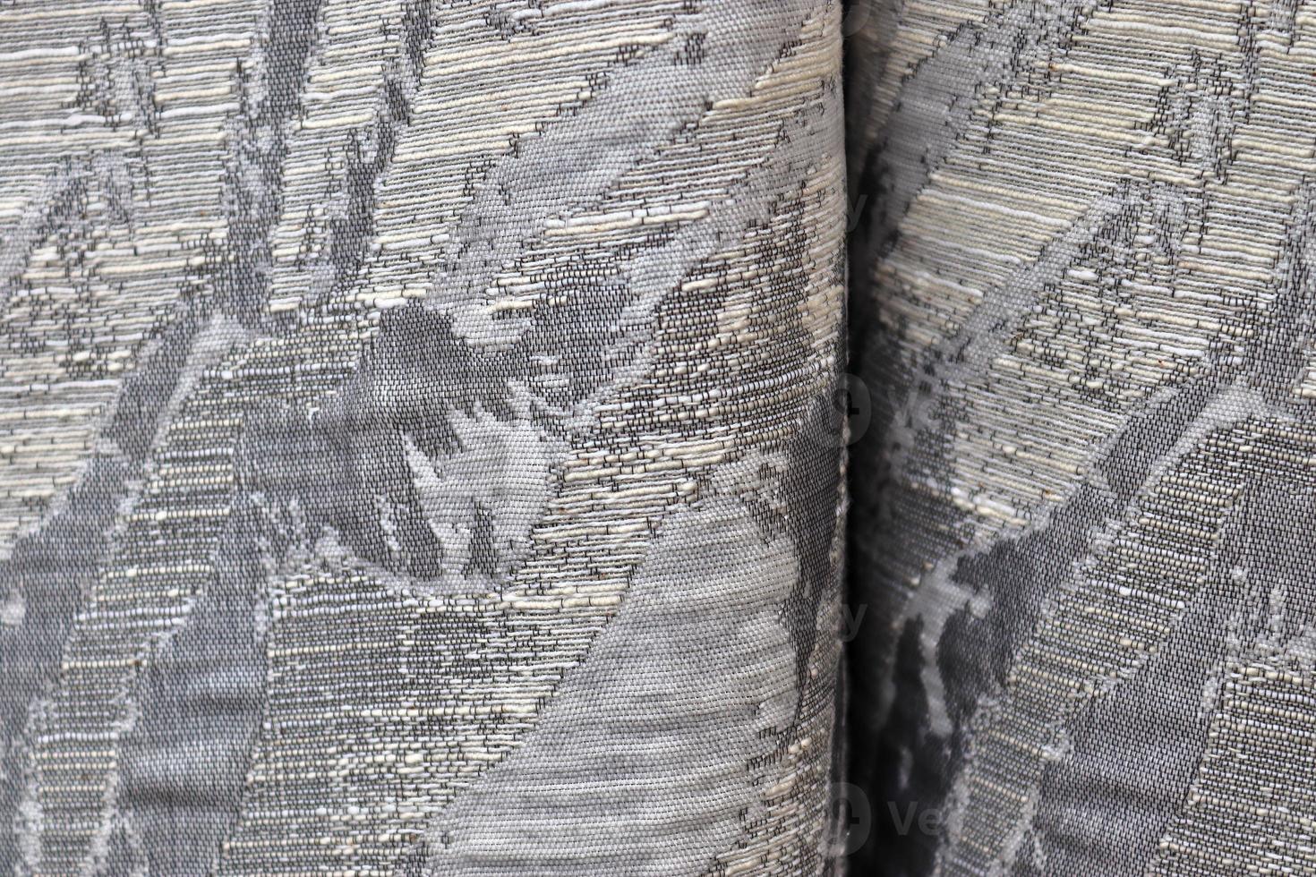 Detailed close up view on samples of cloth and fabrics in different colors found at a fabrics market photo