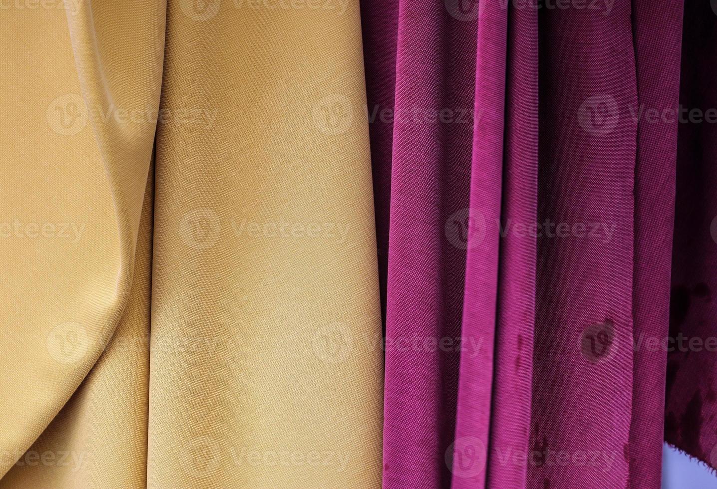 Detailed close up view on samples of cloth and fabrics in different colors found at a fabrics market photo