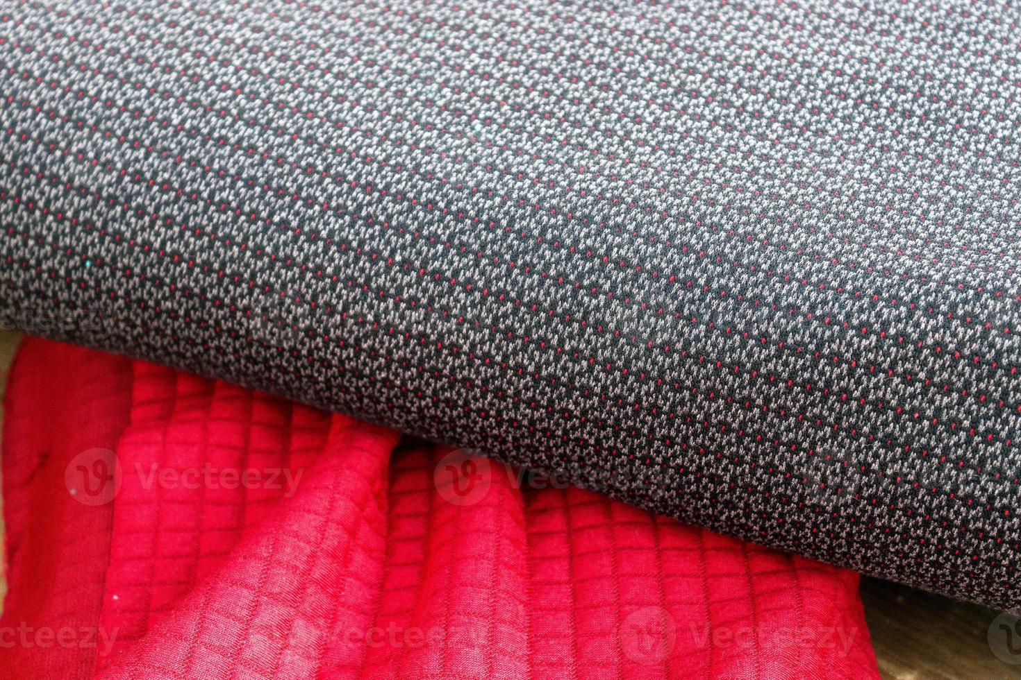 Detailed close up view on samples of cloth and fabrics in different colors found at a fabrics market photo