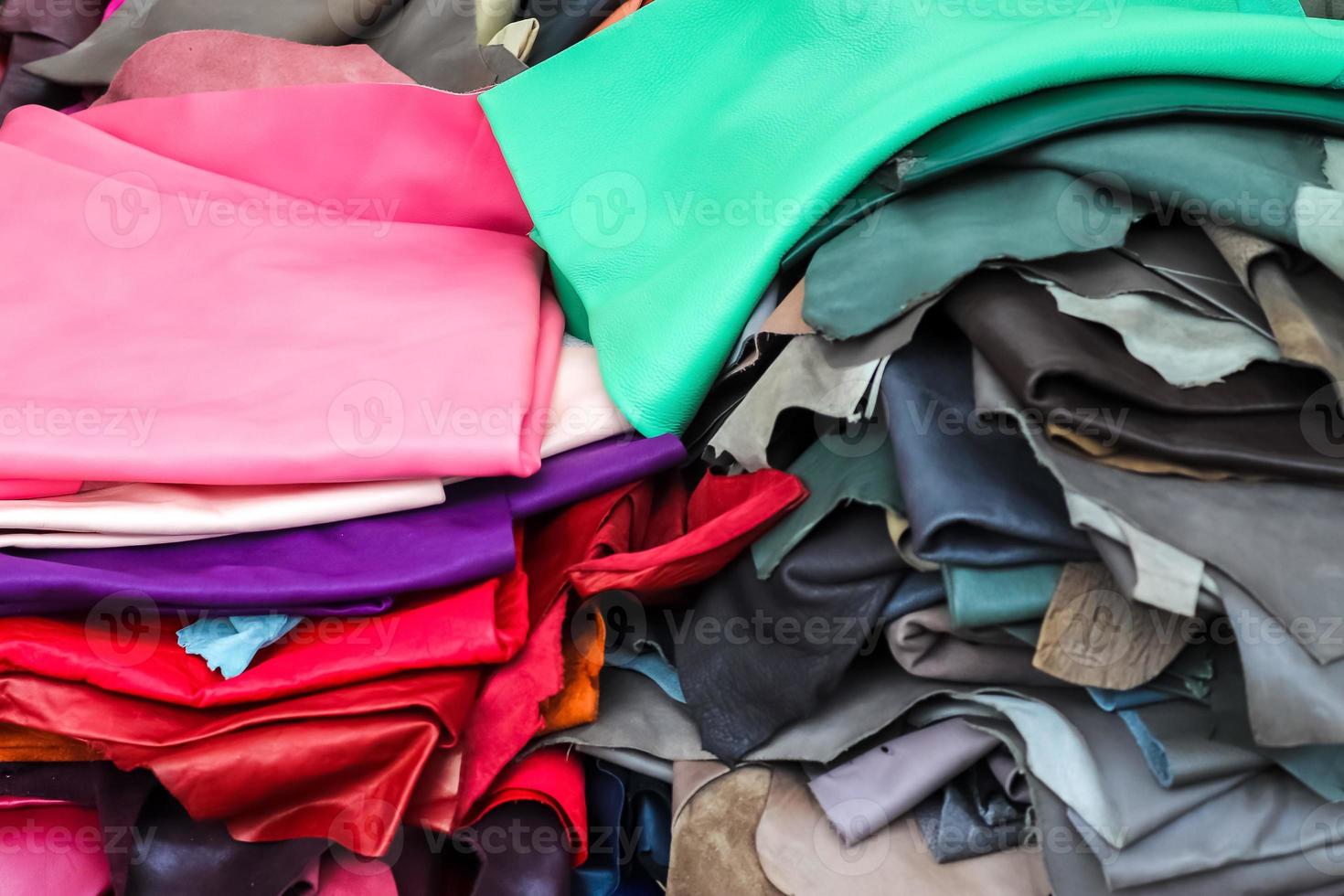 Detailed close up view on samples of cloth and fabrics in different colors found at a fabrics market photo