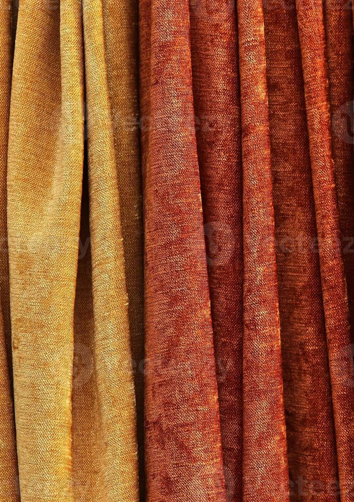 Detailed close up view on samples of cloth and fabrics in different colors found at a fabrics market photo
