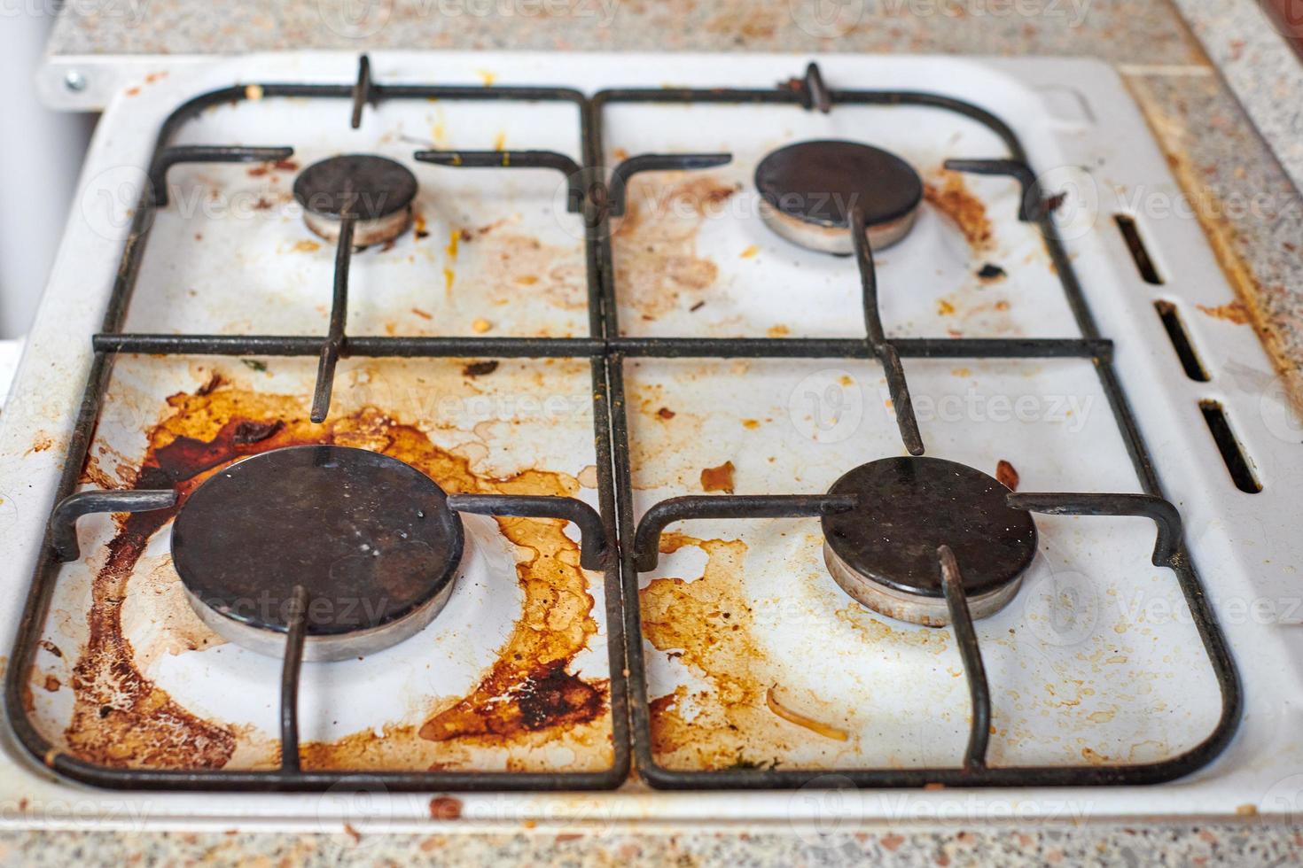 Dirty stove with food leftovers photo