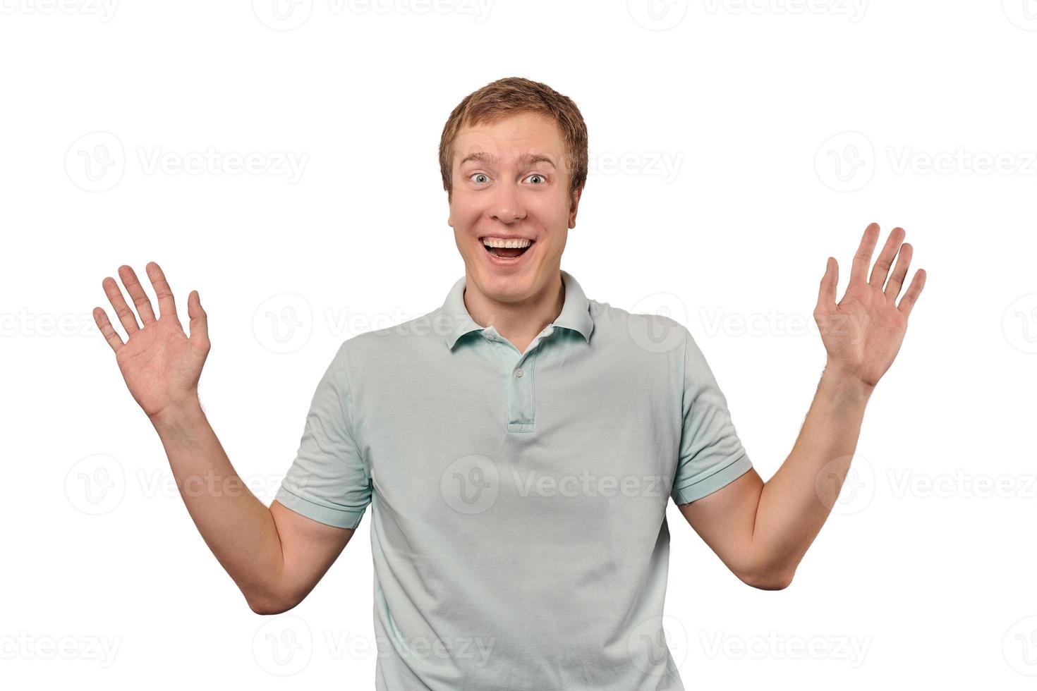 Funny smiling man in T-shirt showing palms of hands, unexpected surprise gesture, white background photo