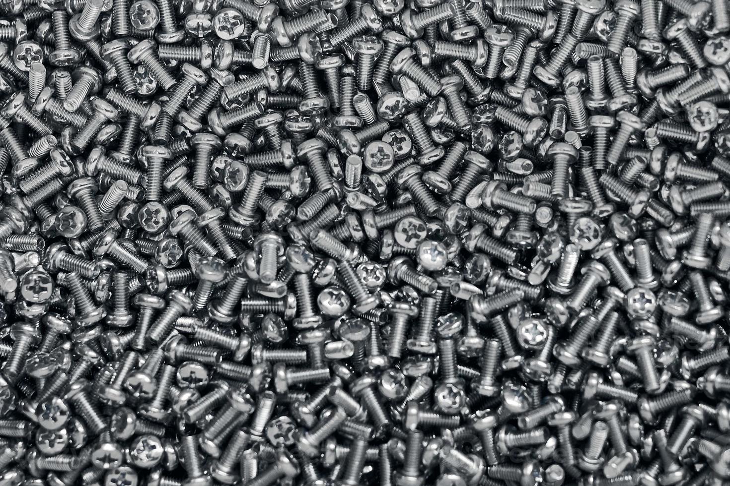 Bunch of galvanized stainless bolts with button head, hardware background, silver screws photo
