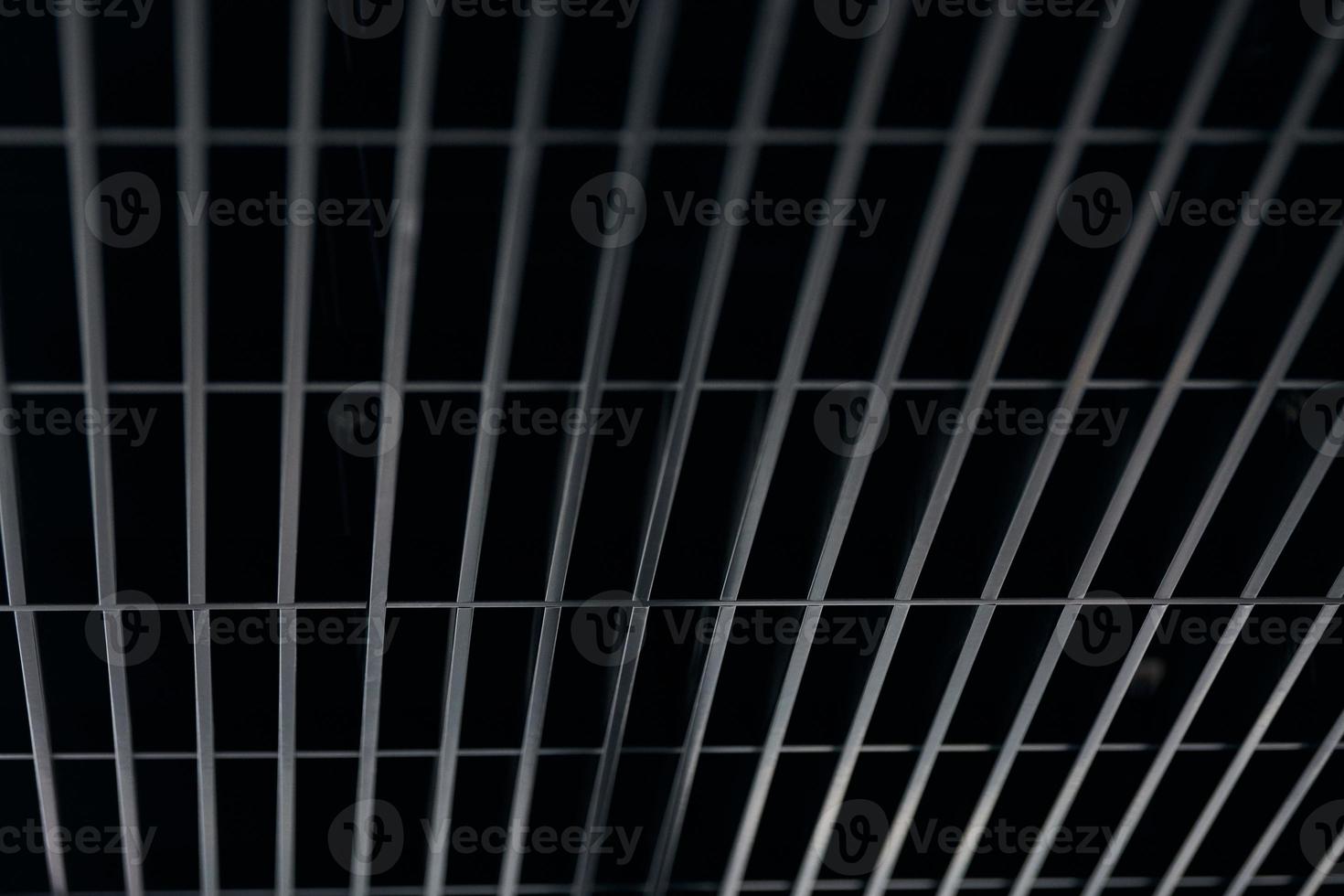 Office grille ceiling. Modern black metal grille ceiling, suspended covering. Abstract design texture. photo