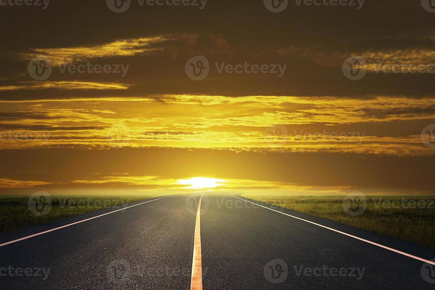 road and grassland at countryside at sunset photo