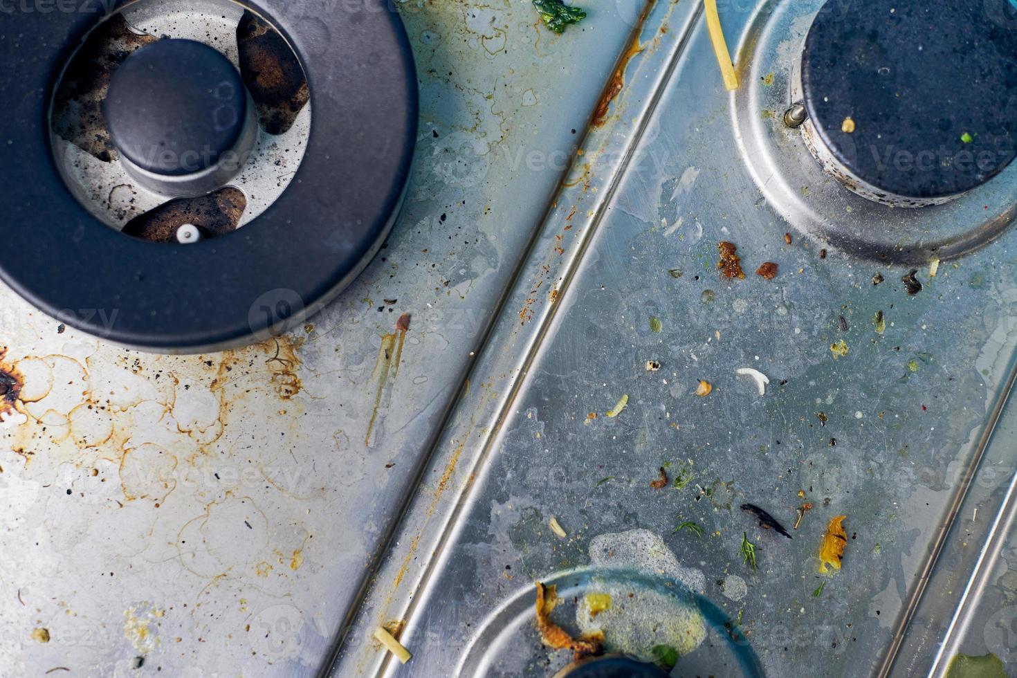 Dirty gas stove with food leftovers and crumbs photo