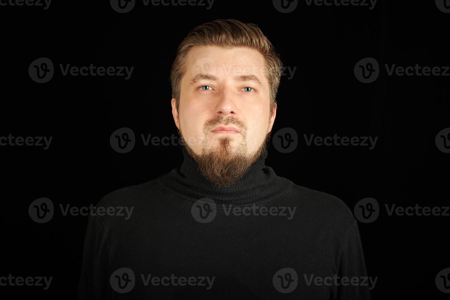 Cute bearded young guy in black polo neck sweater. photo