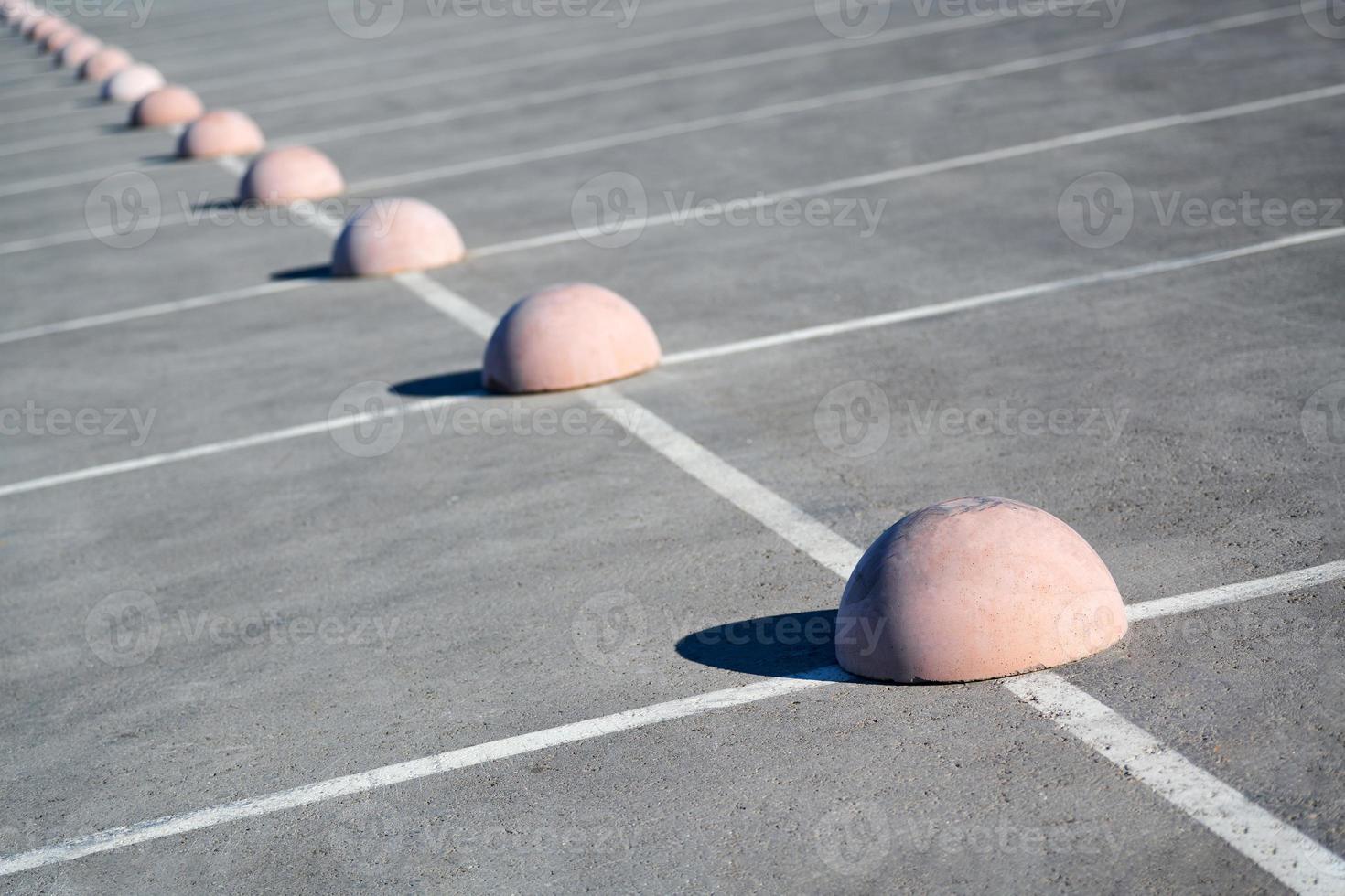 Parking hemispheres. Concrete parking limiter. Protection from car parking. Elements to restrict access to parking zone and control movement of vehicles photo