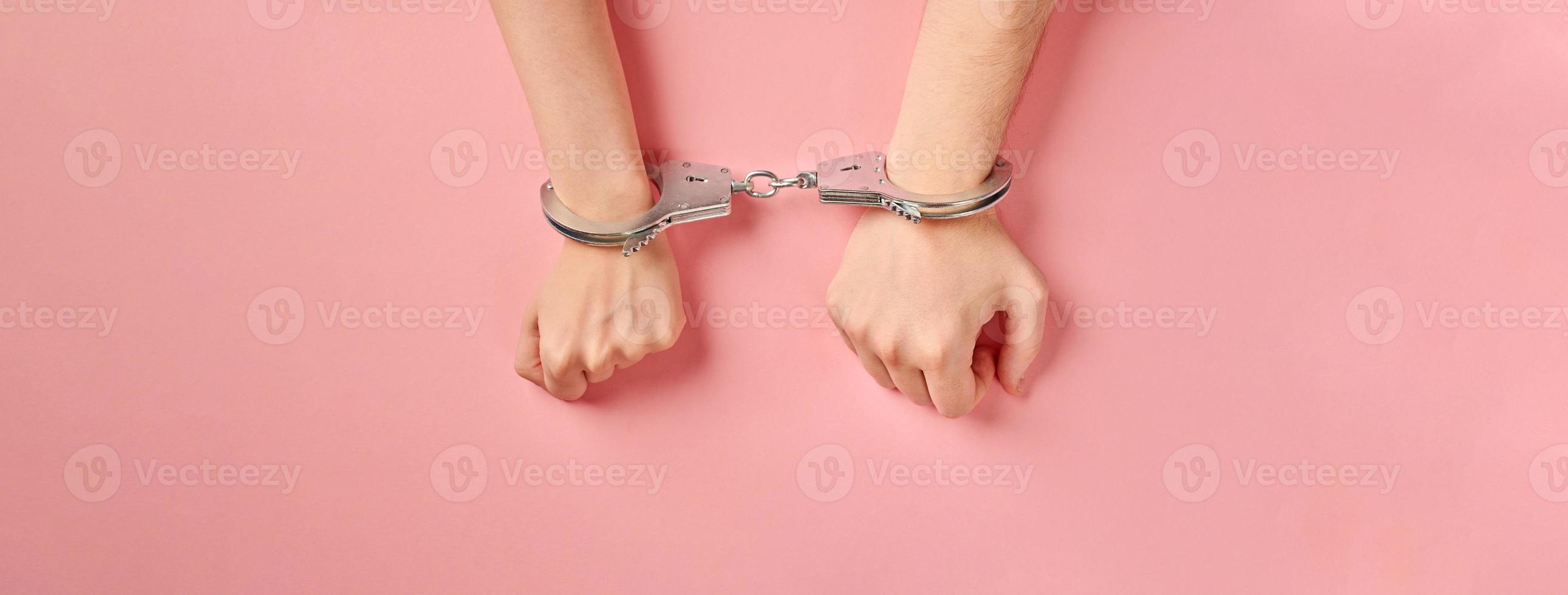 Male and female hands in handcuffs. Love forever. photo