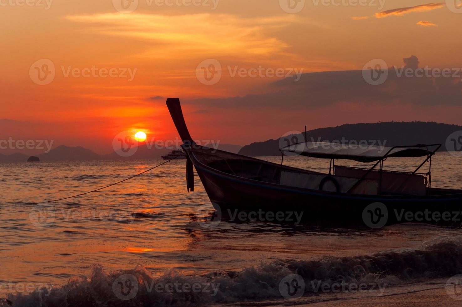 small boat at sunset photo
