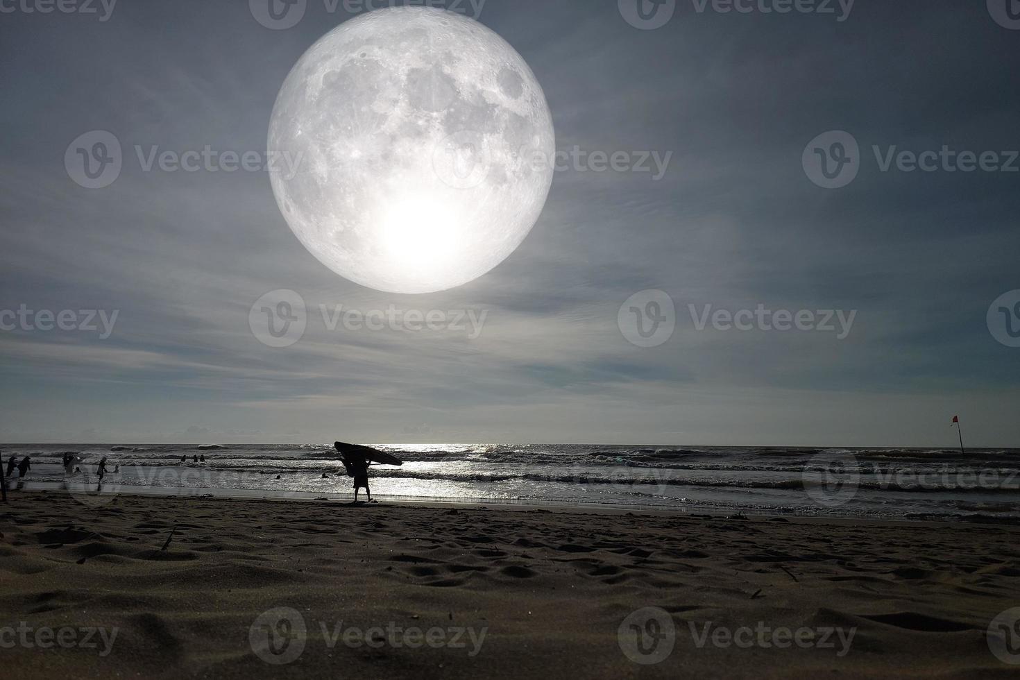 Landscape moon over the horizon on sea and moonlight. Panorama with the luna of night. Grand mystical fantastic view. Mid-Autumn Festival or Halloween concept. The full moon was furnished by NASA. photo