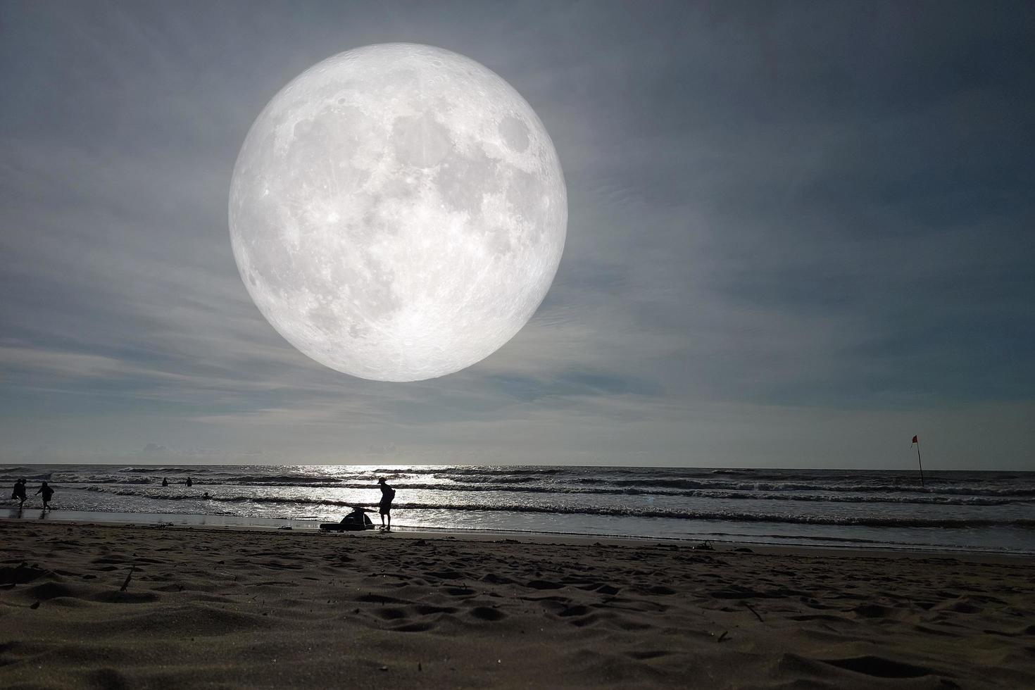 Landscape moon over the horizon on sea and moonlight. Panorama with the luna of night. Grand mystical fantastic view. Mid-Autumn Festival or Halloween concept. photo