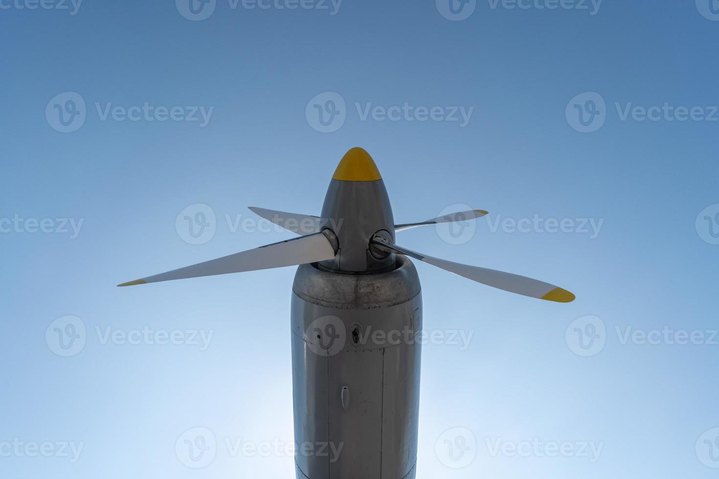 Airplane propeller of military aircraft, copy space. Blue sky sunny background. photo