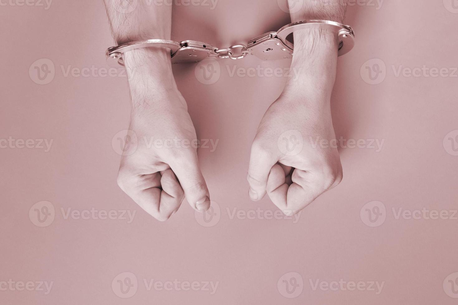 Hands in handcuffs, copy space. photo
