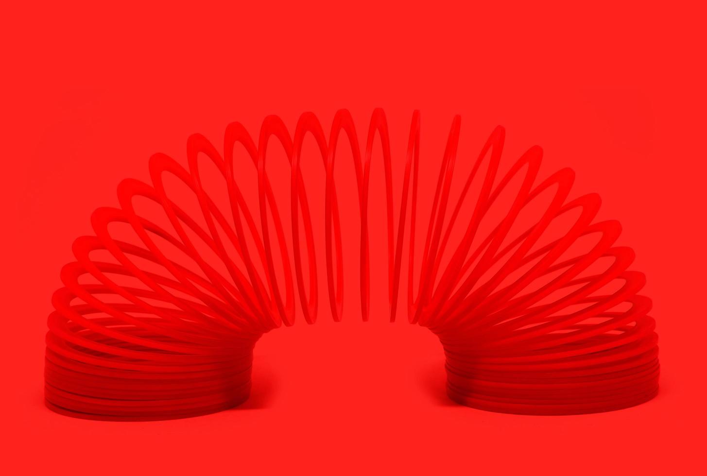 Red sping toy Isolated On red Background. photo