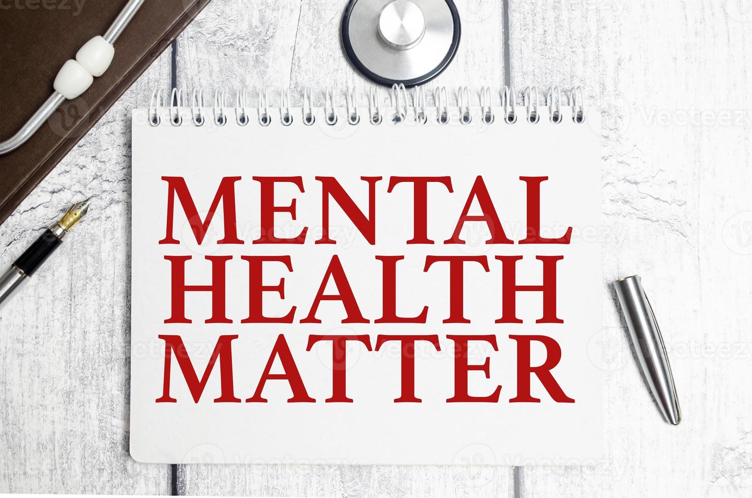 mental health matter words on notebook and stethoscope on white wooden background photo