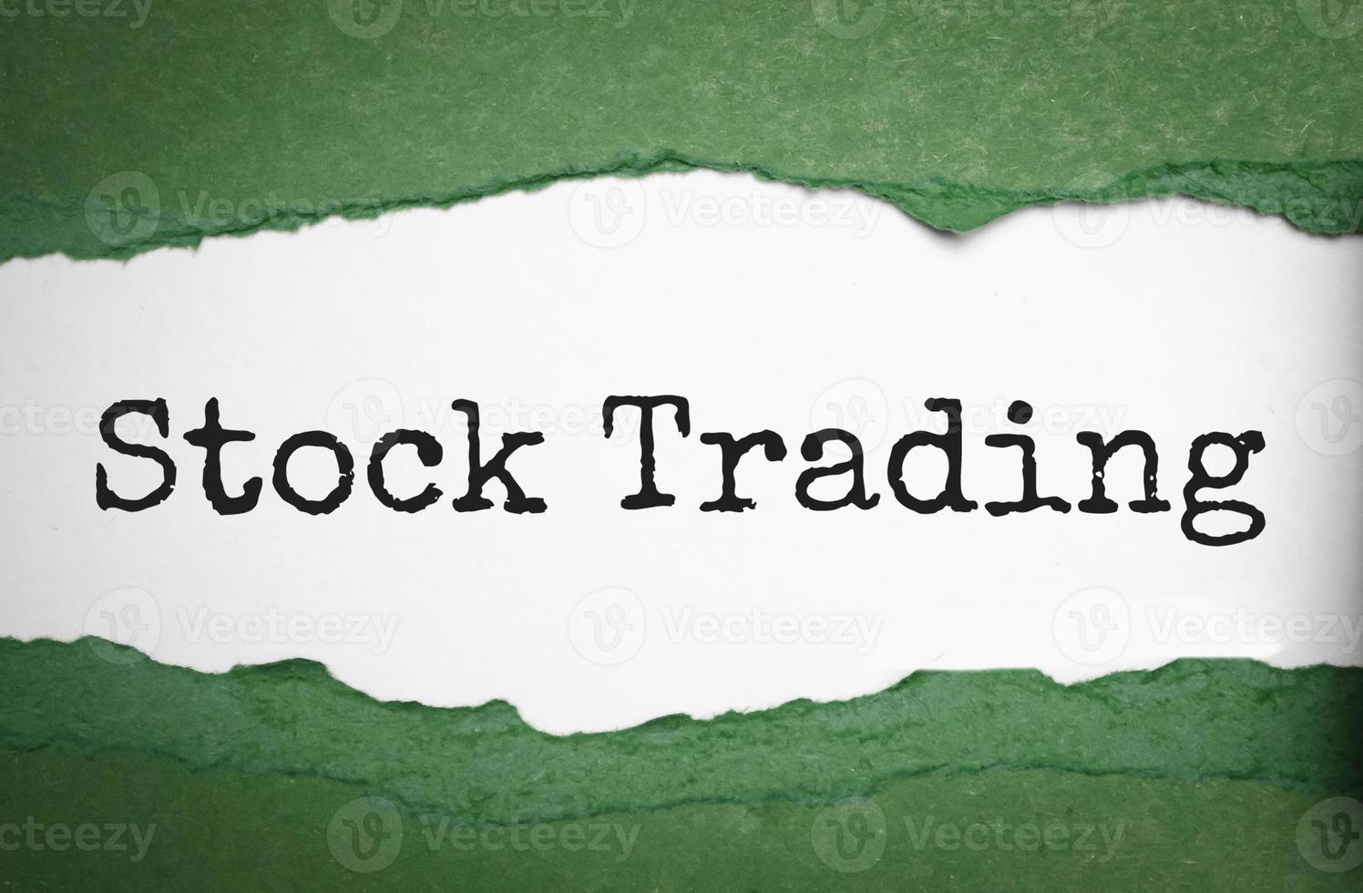 stock trading on torn paper and green background photo