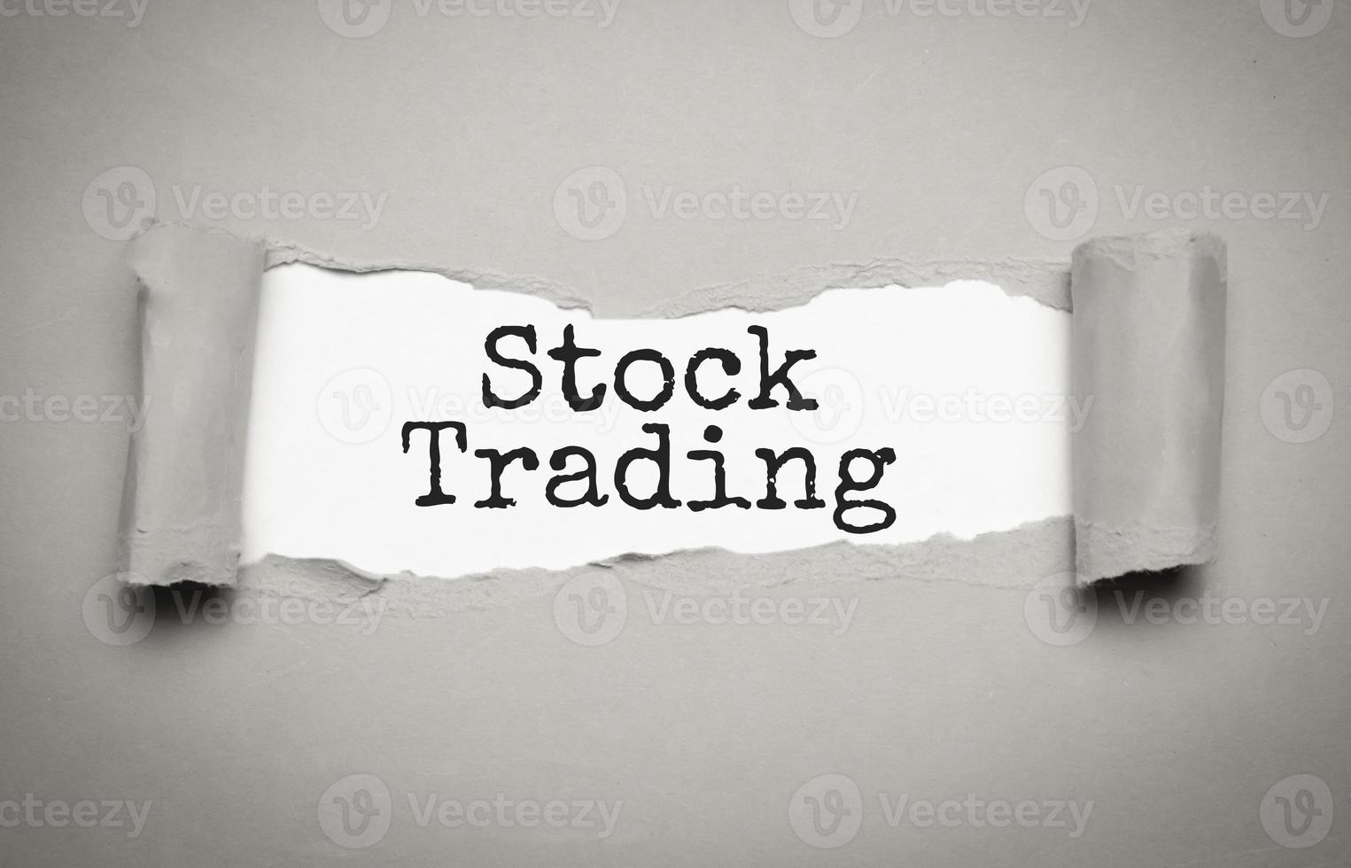 stock trading on torn paper and grey background photo