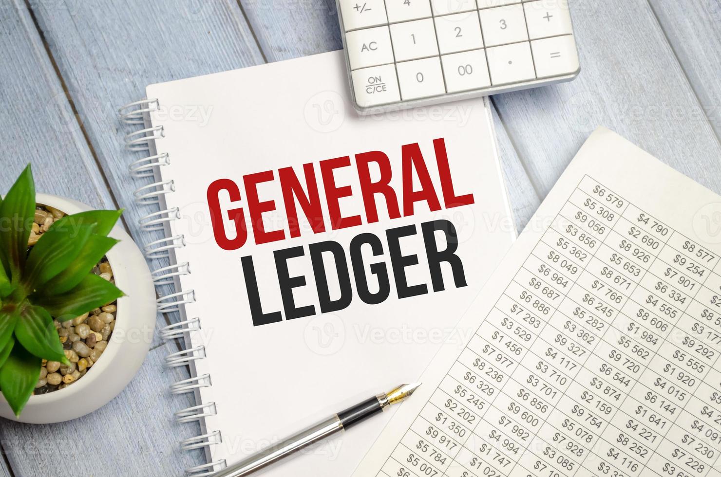 GENERAL LEDGER text written on white notebook with calculator and pen photo