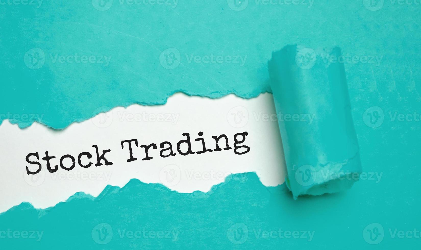 stock trading on torn paper and blue background photo