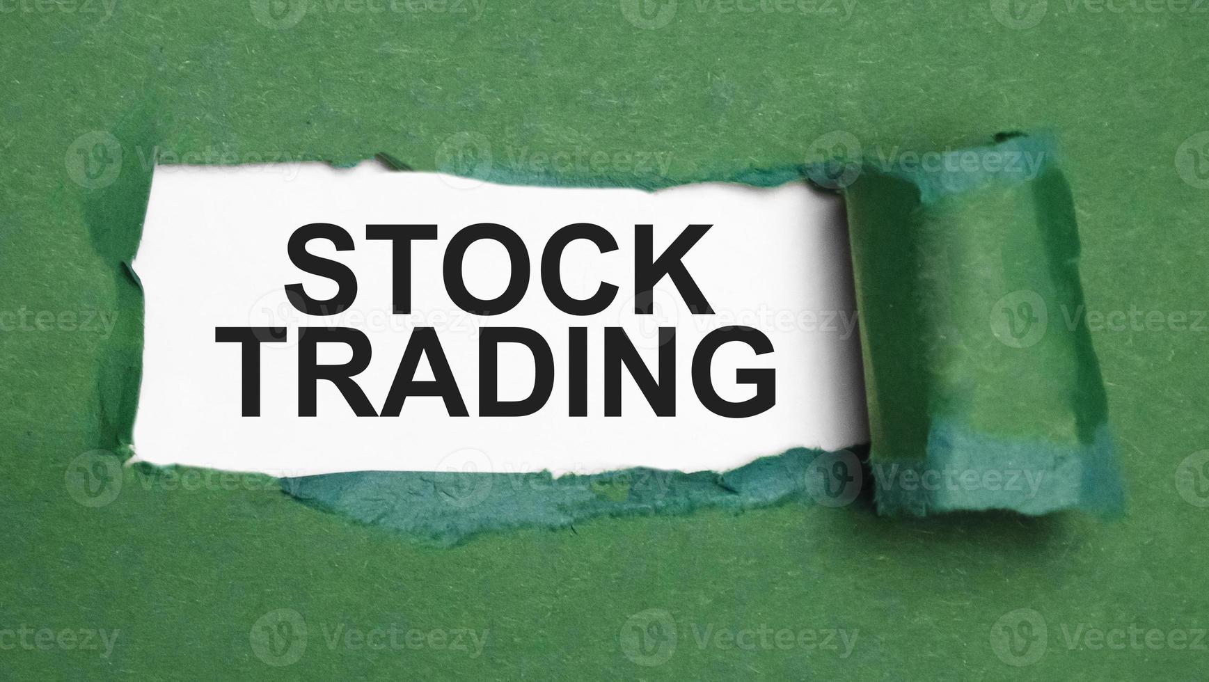 stock trading on torn paper and green background photo