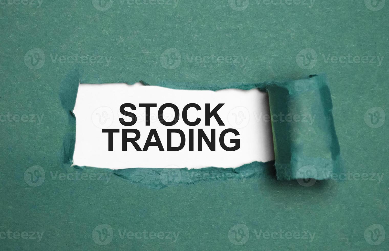 stock trading on torn paper and white background photo