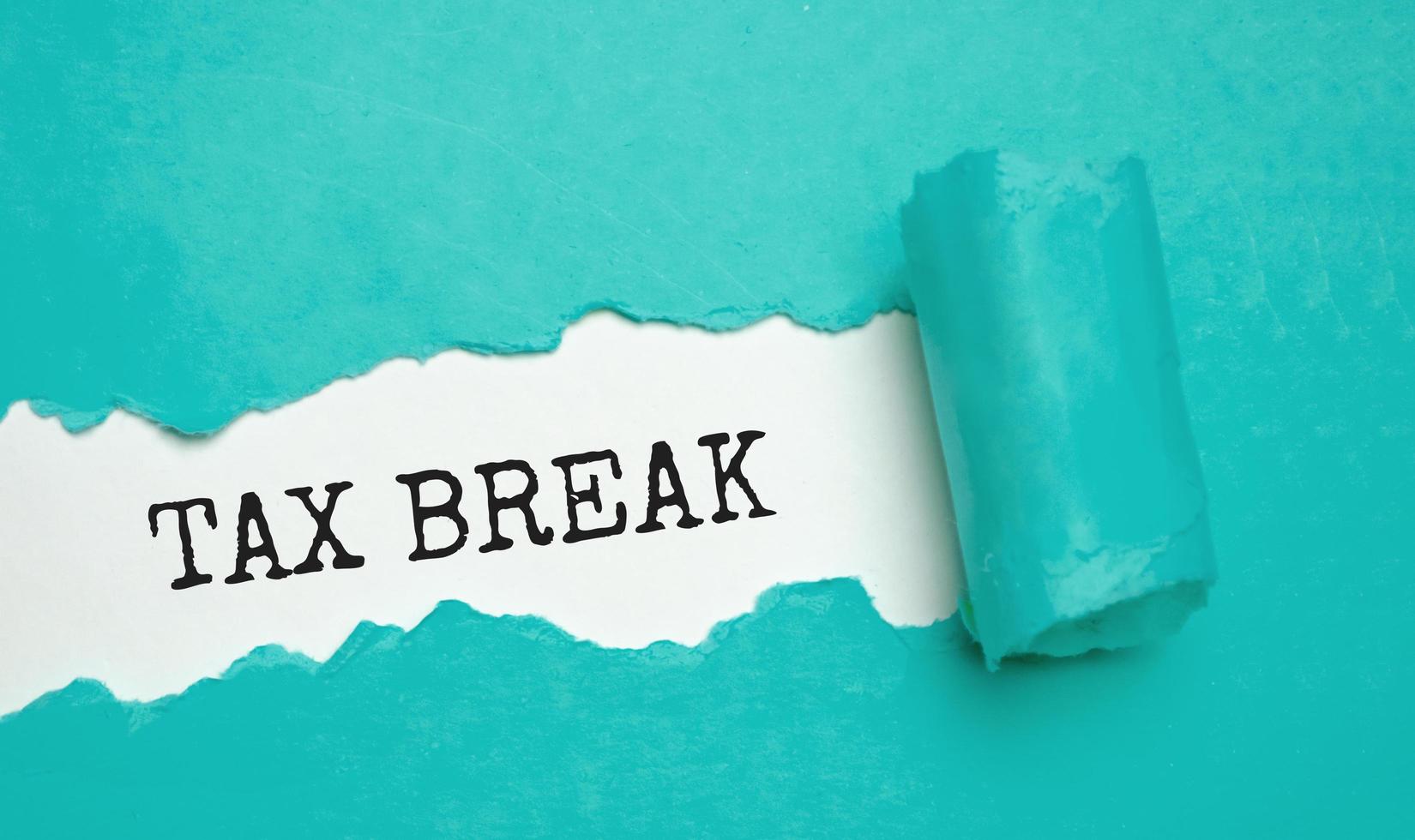 tax break on torn paper and white background photo