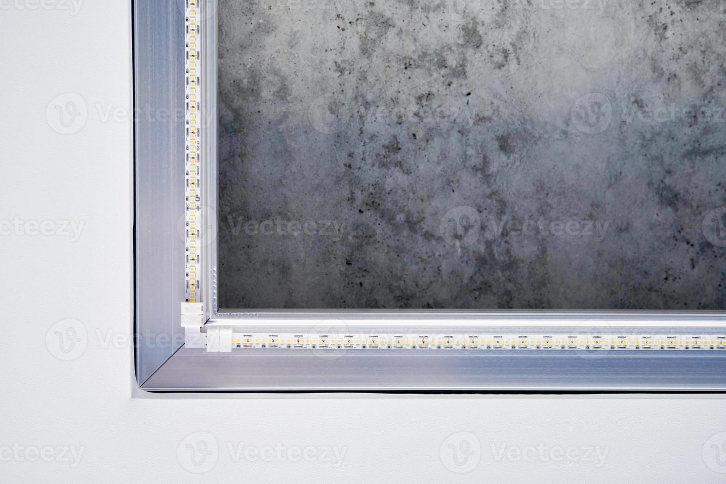 Strip LED light with square aluminum profile on stretch ceiling, close up. Home renovation concept photo