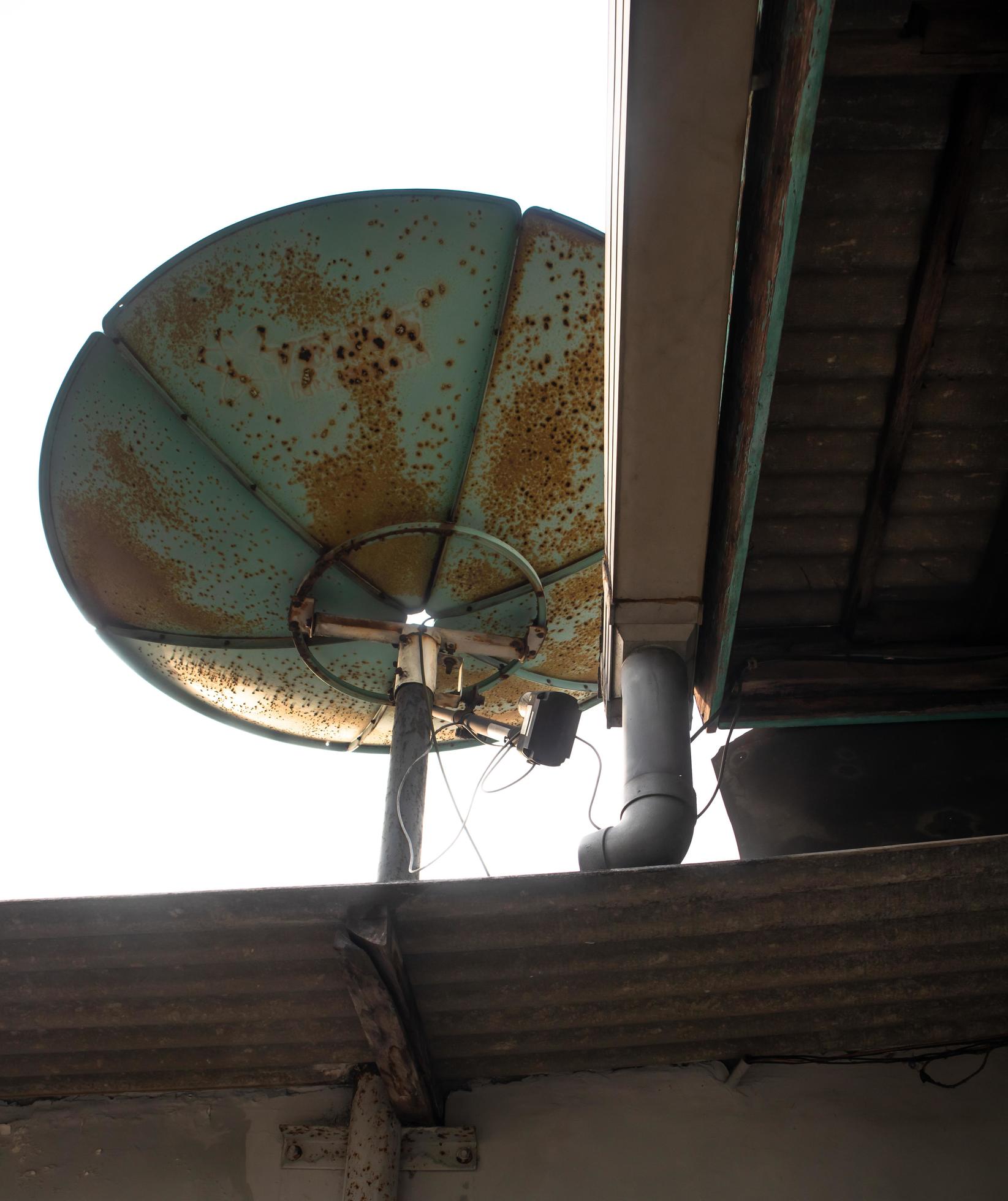 large satellite dish mounted on top of the house 11653221 Stock Photo