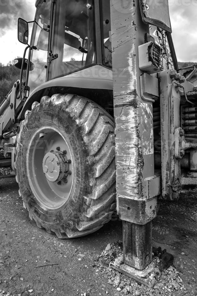 Part of excavator machines in black and white. Vertical view photo