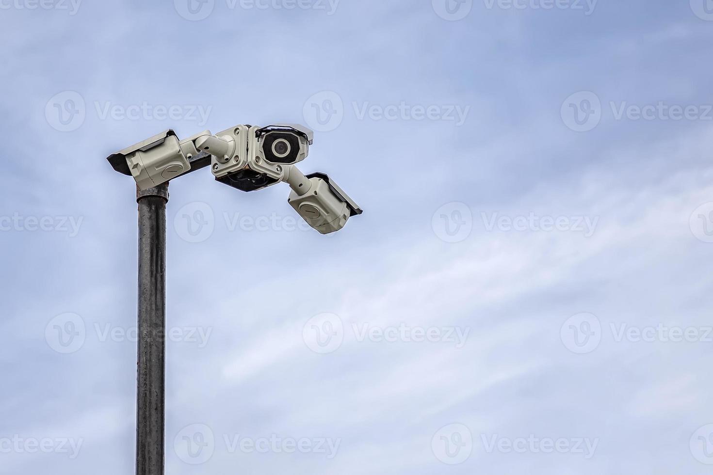 Security CCTV cameras on a pylon in the sky background with copy space photo