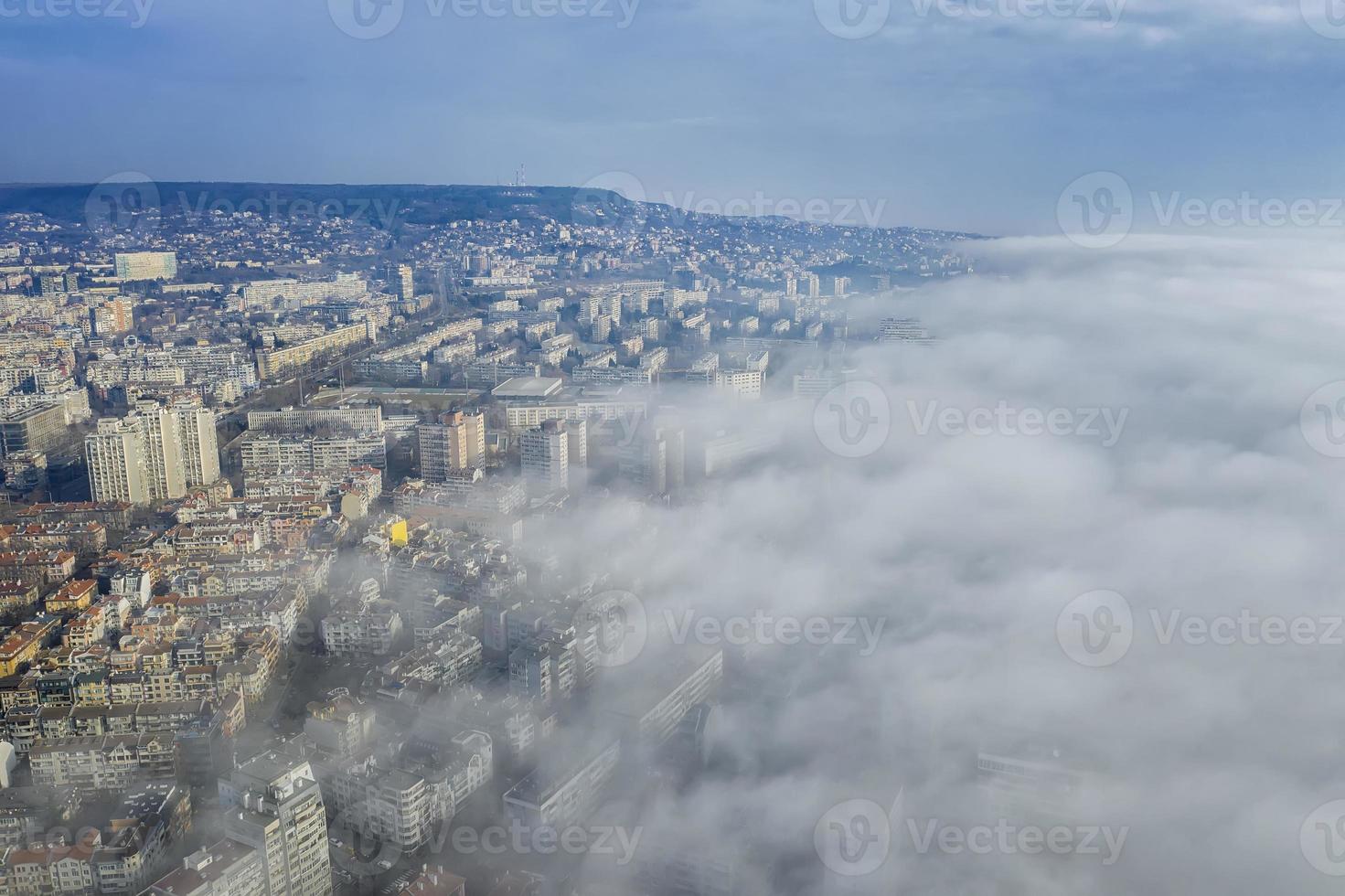 Fog clouds coming over the city from sea, aerial landscape from a drone. View from above. photo