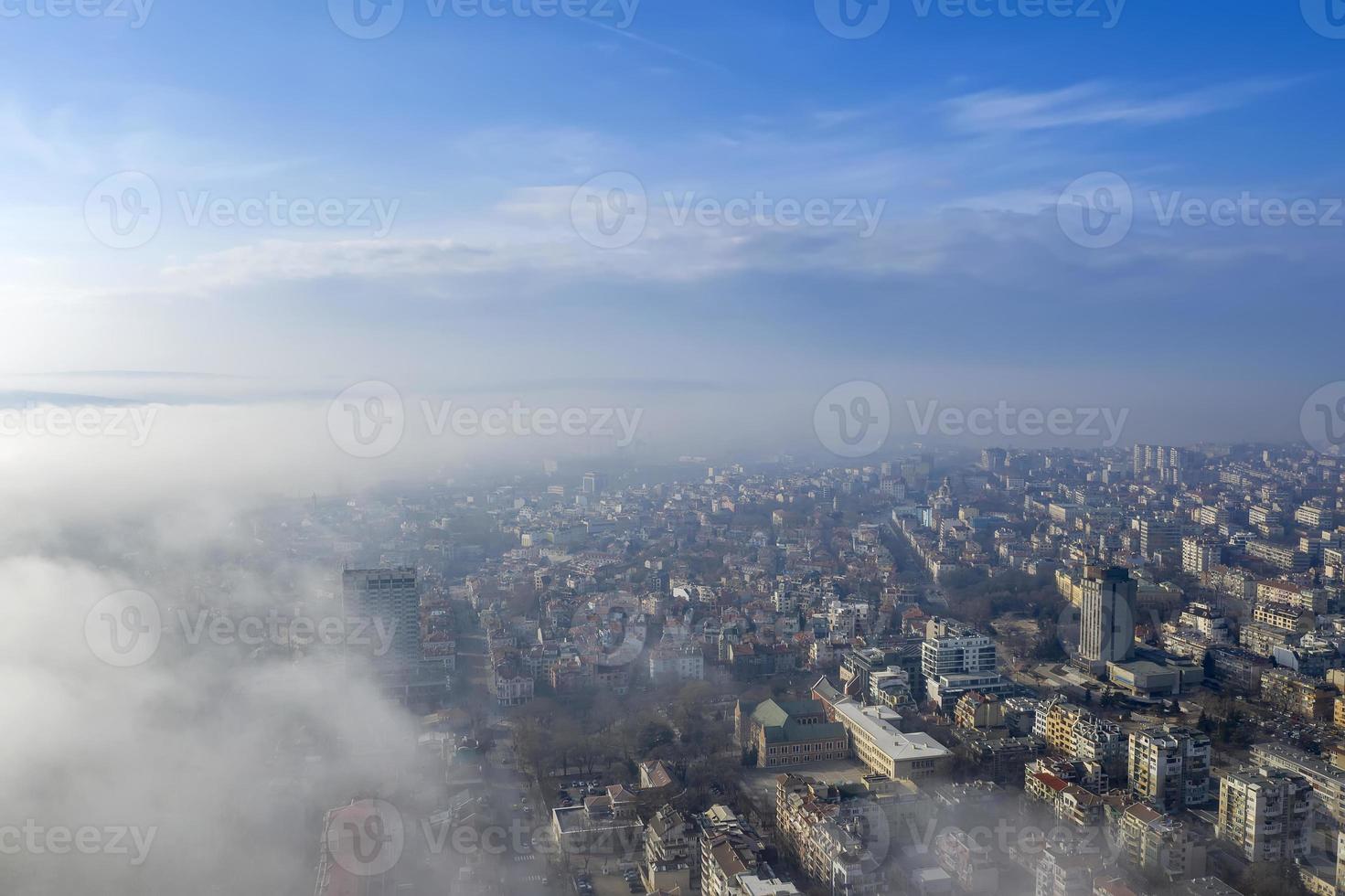 Fog clouds coming over the city from sea, aerial landscape from a drone. View from above. photo