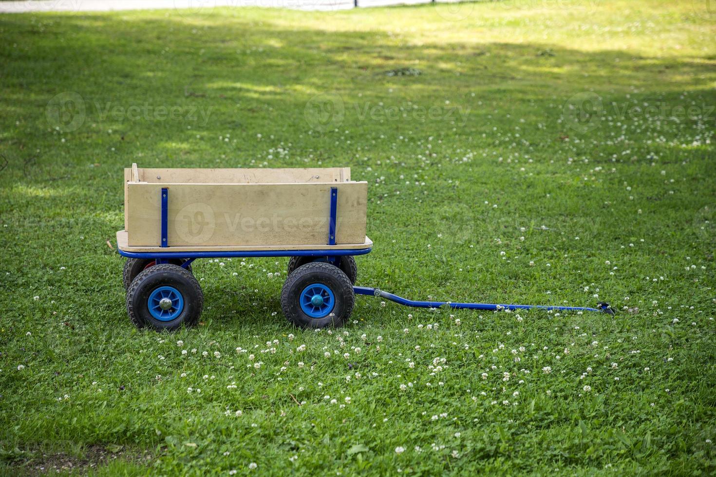 new garden cart with wheels and handles on the green grass photo
