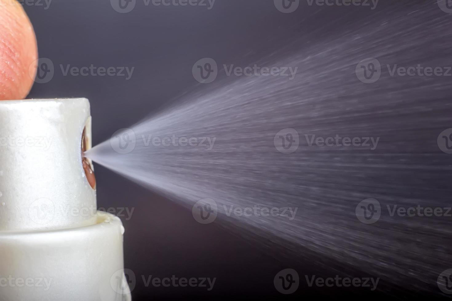 Macro shot for using a spray. Using disinfectant spray to prevent germs, bacteria or viruses photo
