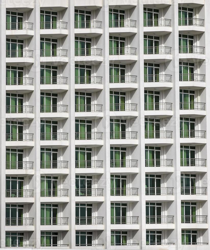 a repeating pattern of windows and a balcony. Windows of a hotel building. photo