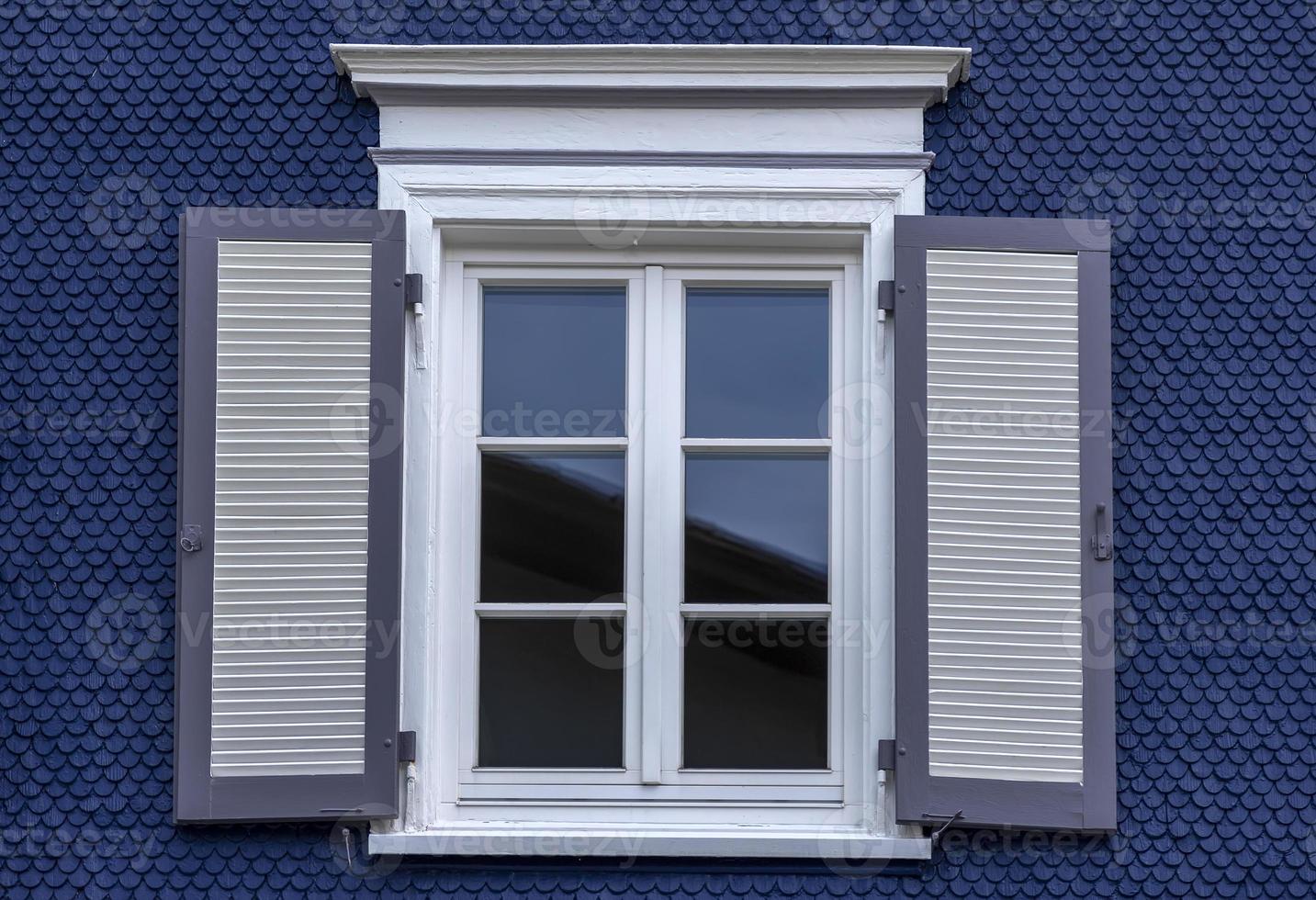 Old wooden window with blinds. No people. Front view. Old fashioned style. photo