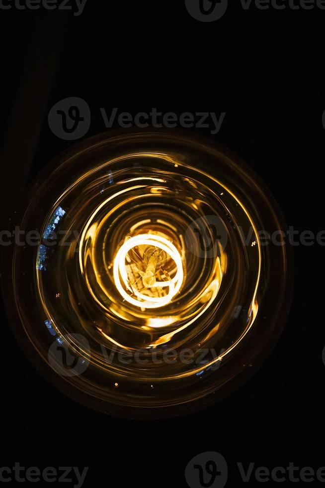 art of lighting of incandescent bulb. Close up. Vertical view photo