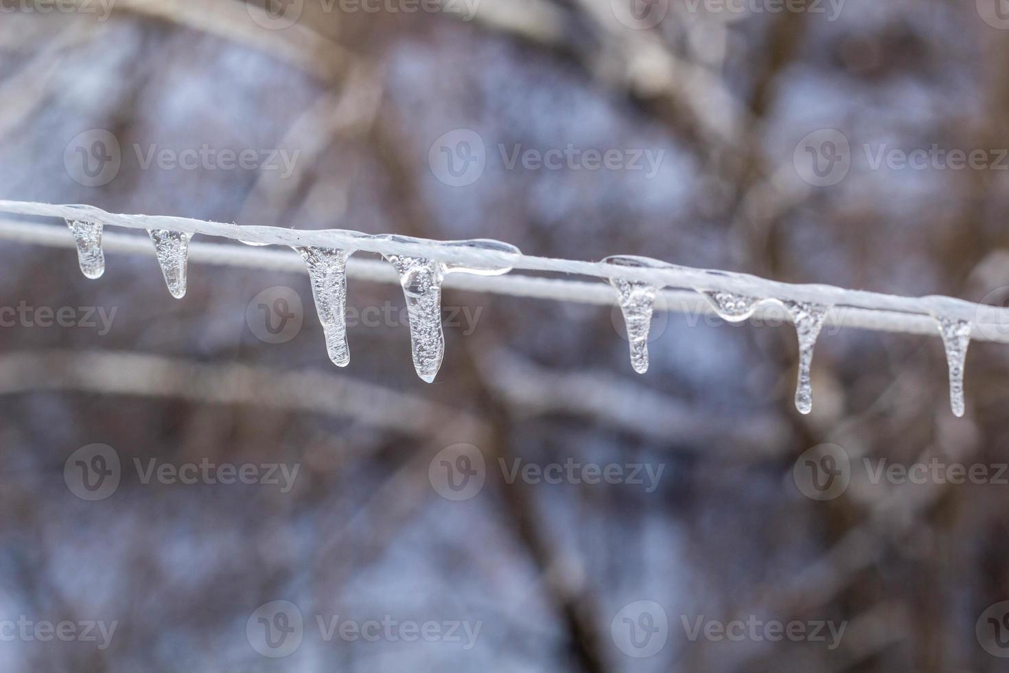 Garland from icicles on a rope in winter. photo