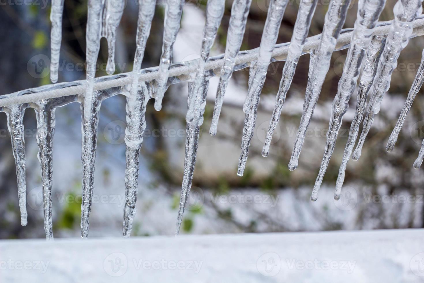 Garland from icicles on a rope in winter. photo