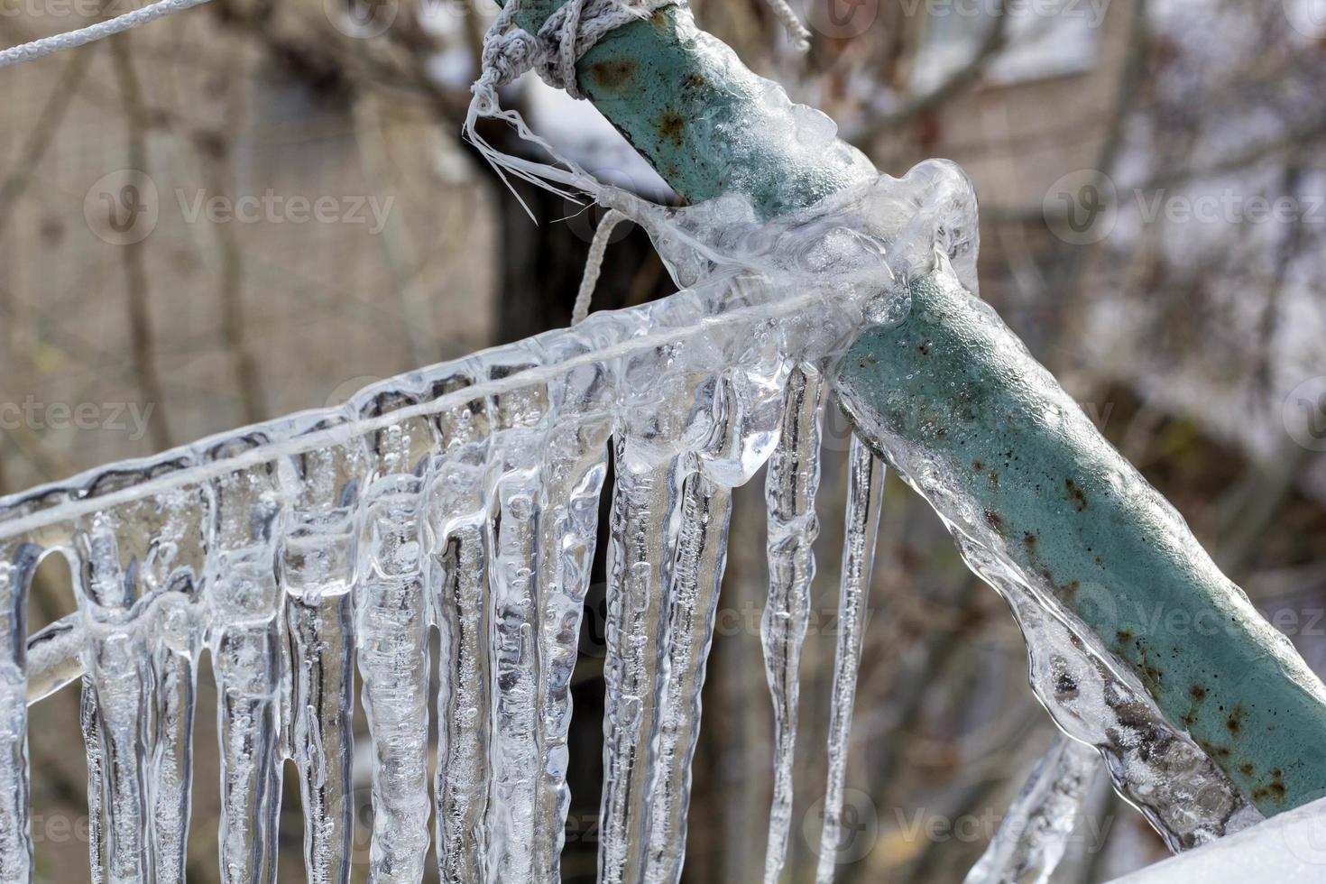 Garland from icicles on a rope in winter. photo