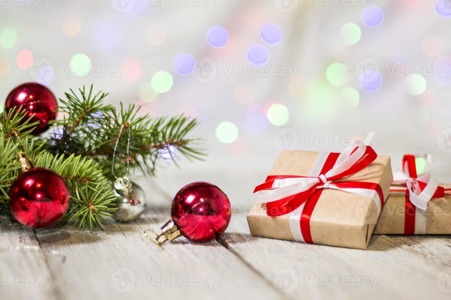 Gift boxes and colorful decorated Christmas tree on bokeh background with copy space photo